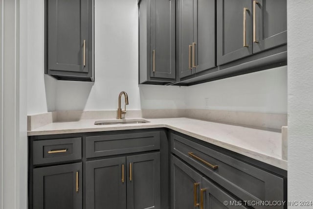 kitchen with gray cabinetry and sink