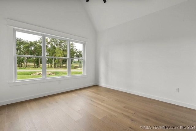 unfurnished room featuring light wood-type flooring and high vaulted ceiling