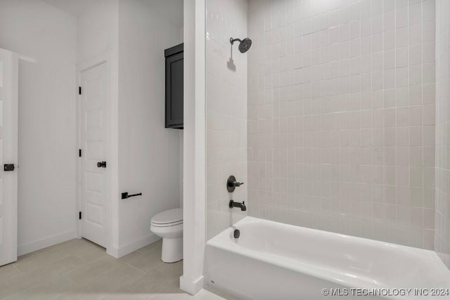 bathroom with tile patterned floors, toilet, and tiled shower / bath