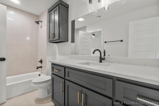 full bathroom featuring vanity, tiled shower / bath combo, ceiling fan, tile patterned flooring, and toilet