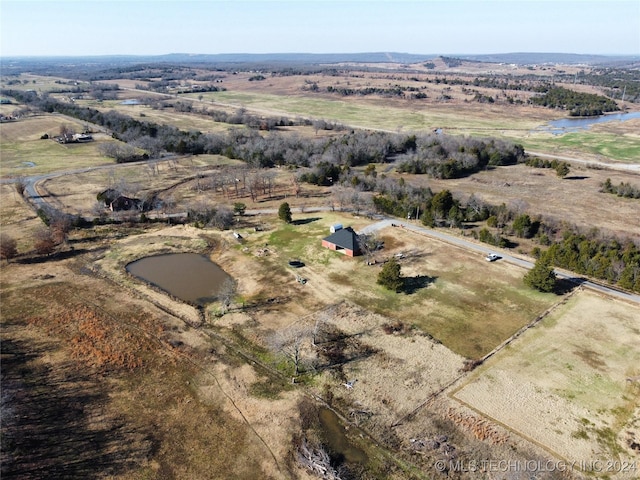 birds eye view of property with a rural view and a water view