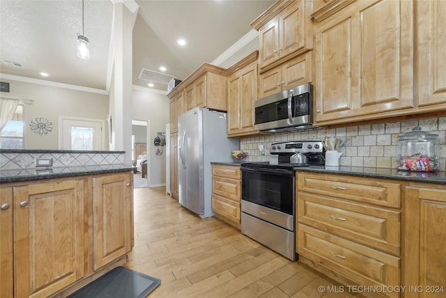 kitchen featuring light wood-type flooring, ornamental molding, tasteful backsplash, decorative light fixtures, and stainless steel appliances