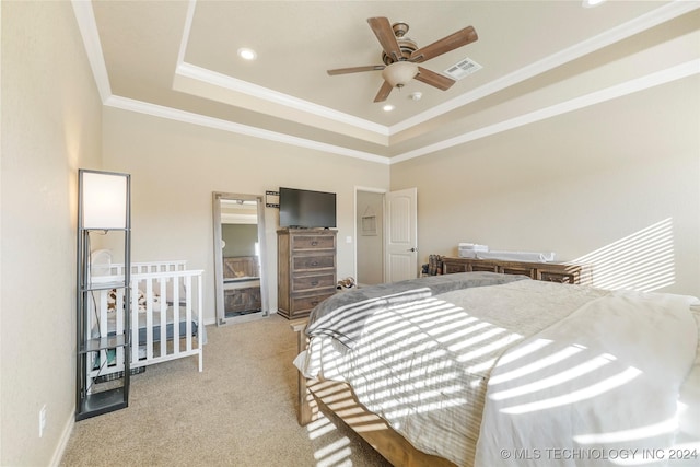 bedroom featuring a tray ceiling, ceiling fan, light colored carpet, and ornamental molding