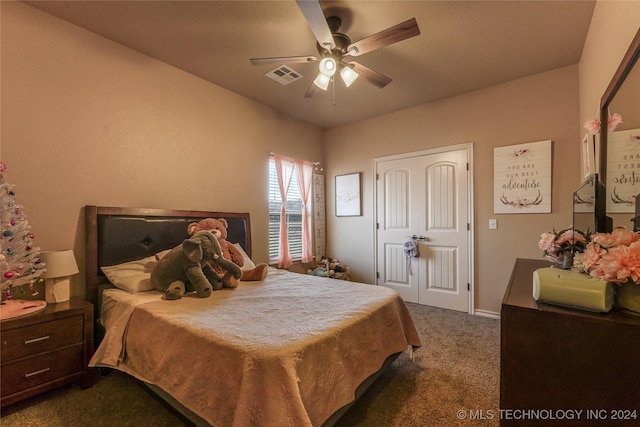 bedroom featuring dark colored carpet, a closet, and ceiling fan