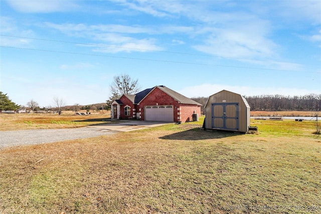 view of yard featuring a rural view and a storage shed