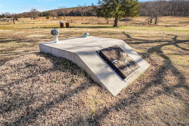 view of storm shelter with a rural view