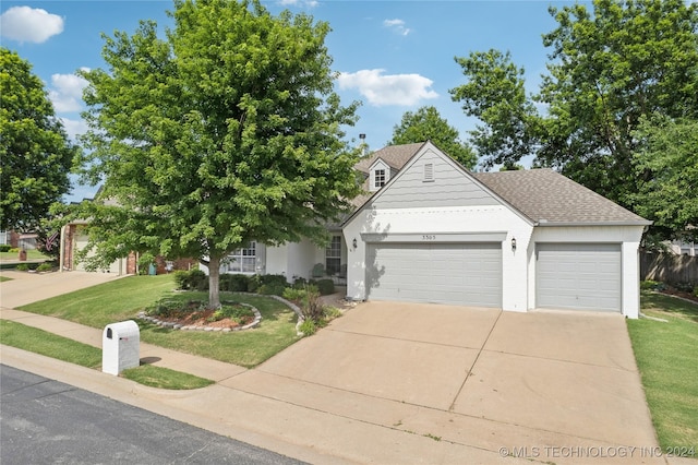 view of front of house featuring a front yard and a garage