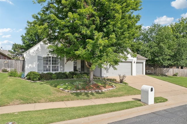 view of property hidden behind natural elements with a front yard and a garage