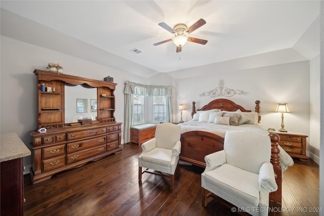 bedroom with vaulted ceiling, ceiling fan, and dark hardwood / wood-style floors