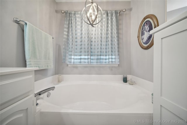 bathroom featuring a washtub and a chandelier