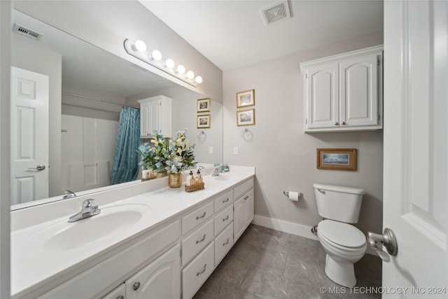 bathroom featuring curtained shower, tile patterned flooring, vanity, and toilet