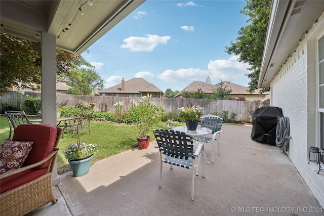 view of patio featuring a grill