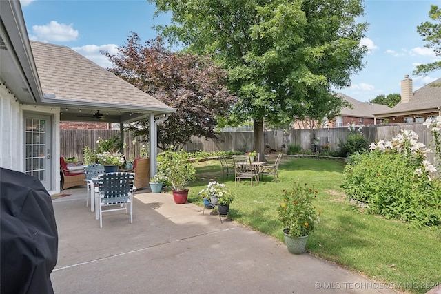 view of patio / terrace with ceiling fan and a grill