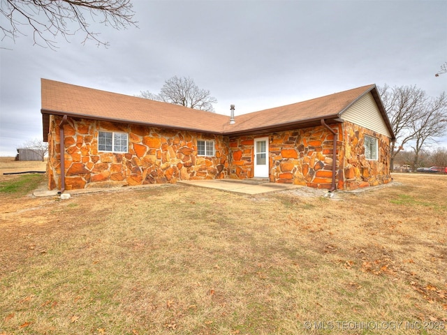 back of property featuring a lawn and a patio