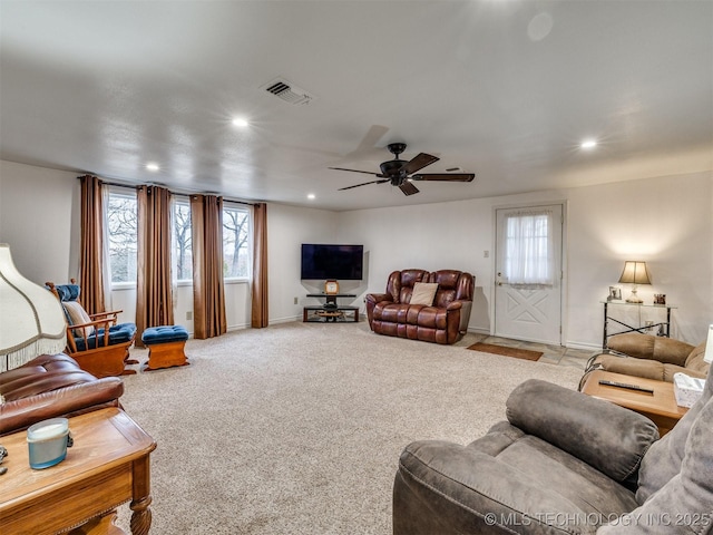 carpeted living room with ceiling fan