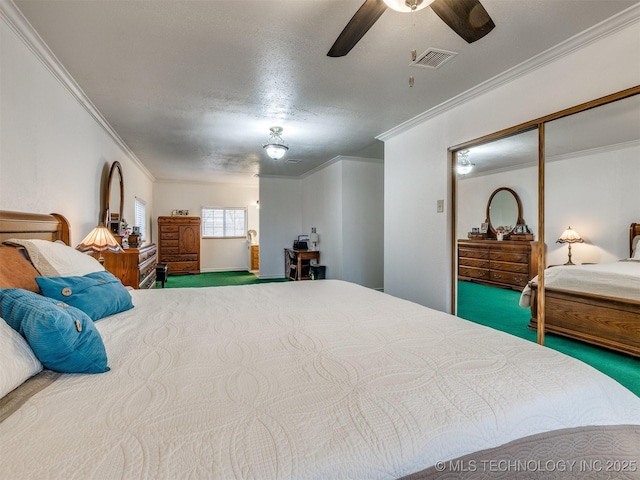 bedroom featuring crown molding, ceiling fan, a textured ceiling, carpet floors, and a closet