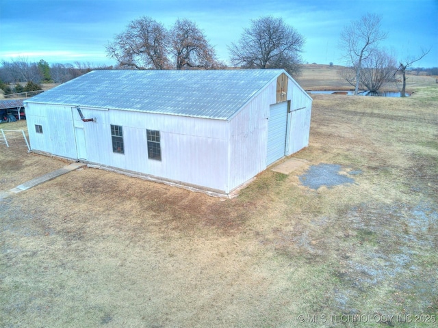 view of outbuilding featuring a lawn and a garage