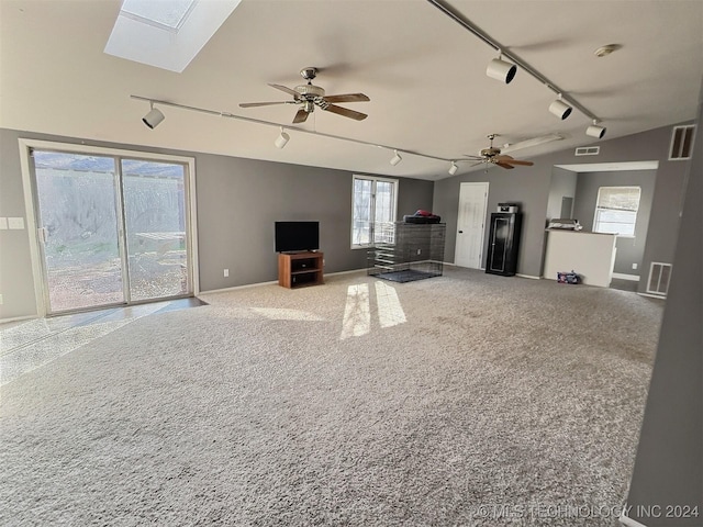 unfurnished living room with carpet, rail lighting, and ceiling fan