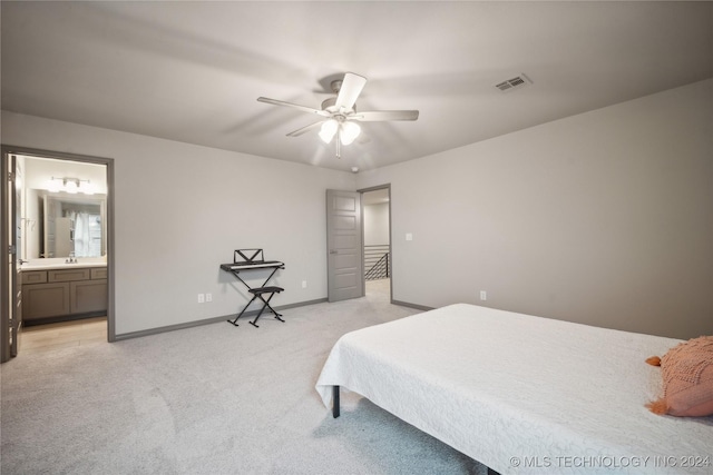 carpeted bedroom with connected bathroom, sink, and ceiling fan