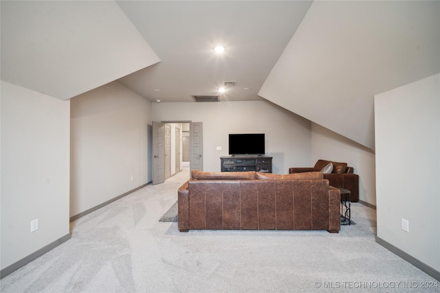 carpeted living room featuring lofted ceiling