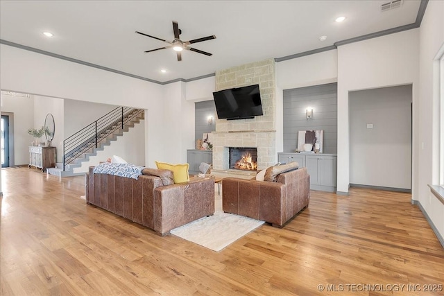 4255 S 173rd E Ave, Tulsa, OK 74134 - living room featuring light wood finished floors, stairway, crown molding, ceiling fan, and a stone fireplace