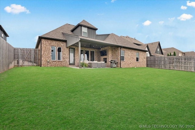 4255 S 173rd E Ave, Tulsa, OK 74134 - back of house featuring a fenced backyard, brick siding, an outdoor living space, and board and batten siding