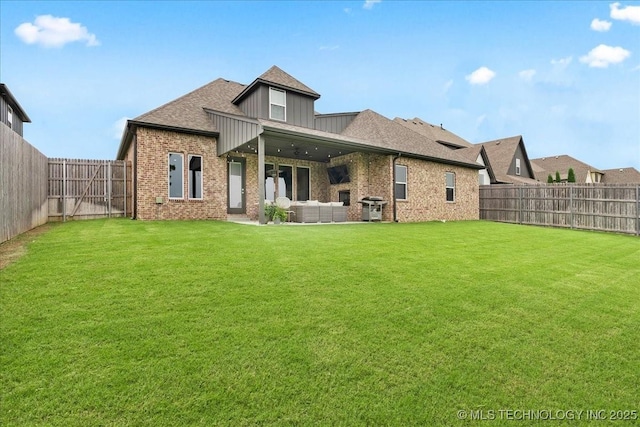 4255 S 173rd E Ave, Tulsa, OK 74134 - back of property with brick siding, a fenced backyard, board and batten siding, an outdoor living space, and roof with shingles