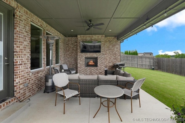 4255 S 173rd E Ave, Tulsa, OK 74134 - fenced backyard featuring a ceiling fan, an outdoor living space with a fireplace, a patio, and area for grilling