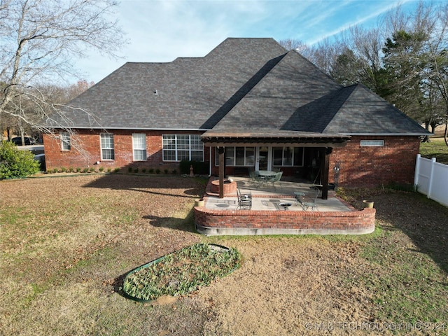 back of house with a yard and a patio