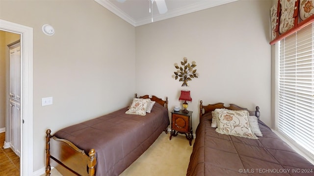 bedroom with ceiling fan, ornamental molding, and multiple windows