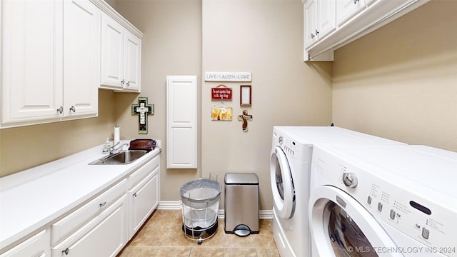 washroom featuring cabinets, light tile patterned floors, sink, and washing machine and clothes dryer