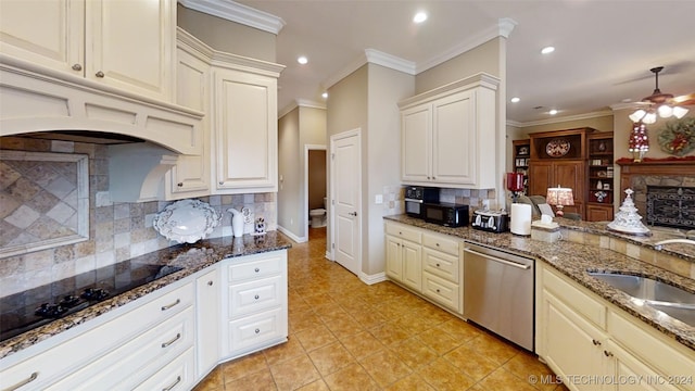 kitchen with black appliances, crown molding, sink, and tasteful backsplash