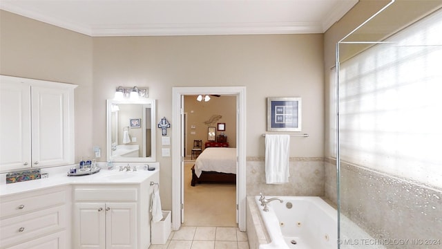 bathroom featuring vanity, tiled bath, tile patterned floors, and crown molding