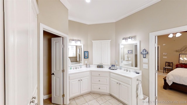 bathroom featuring tile patterned flooring, vanity, and crown molding