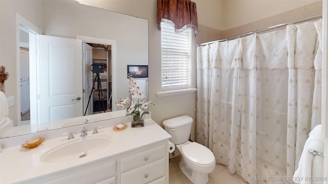 bathroom with tile patterned flooring, a shower with curtain, vanity, and toilet