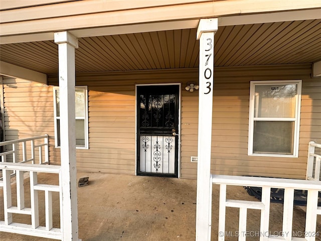 view of exterior entry with a porch