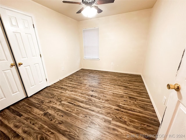 unfurnished room featuring ceiling fan and dark wood-type flooring