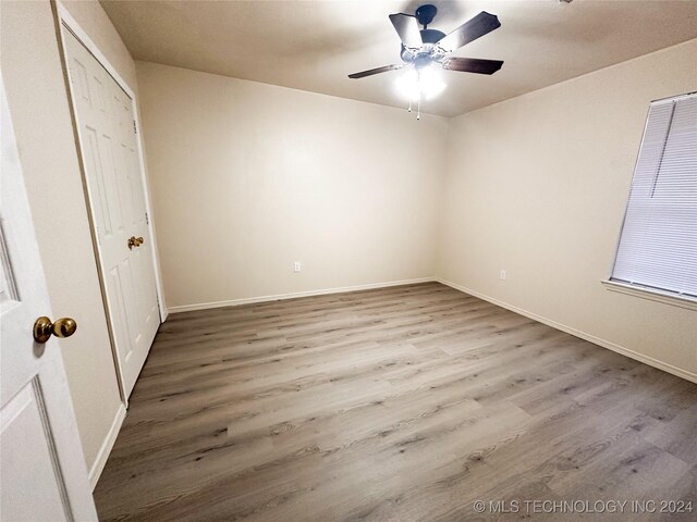 unfurnished bedroom featuring hardwood / wood-style floors and ceiling fan