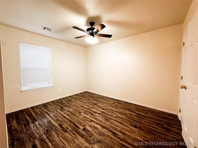 empty room featuring ceiling fan and dark wood-type flooring