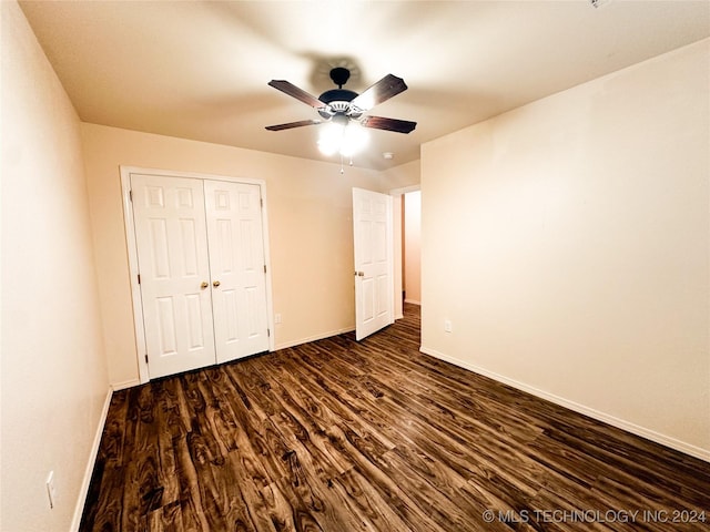 unfurnished bedroom featuring a closet, ceiling fan, and dark hardwood / wood-style flooring