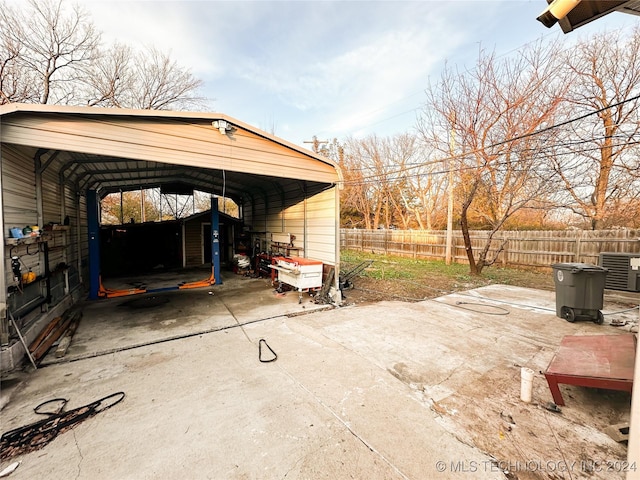 view of patio featuring central air condition unit and a carport