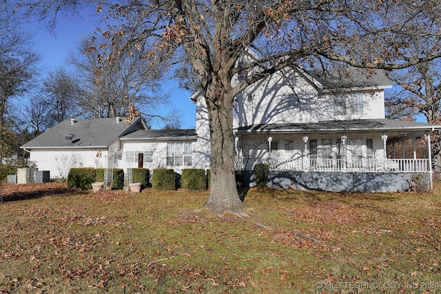 rear view of property with a yard and central AC unit