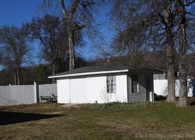 exterior space with a lawn and an outbuilding