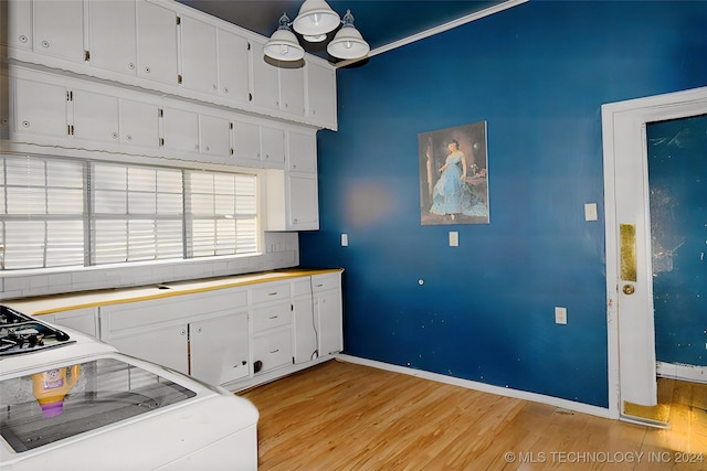 kitchen featuring white cabinets and light wood-type flooring