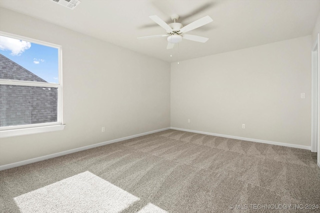 carpeted empty room featuring ceiling fan