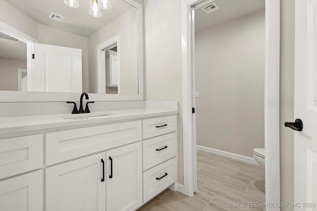 bathroom with toilet and vanity