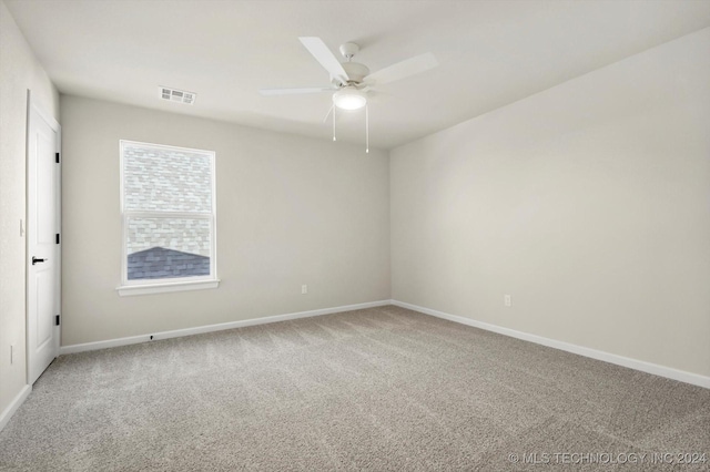 carpeted spare room featuring ceiling fan