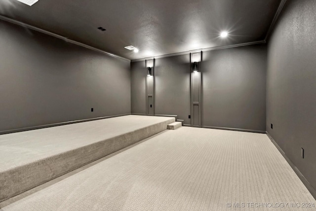 home theater room featuring carpet floors and crown molding