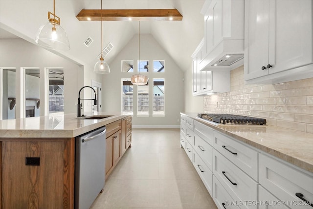 kitchen featuring a center island with sink, appliances with stainless steel finishes, pendant lighting, white cabinets, and sink