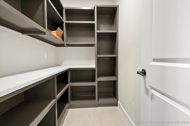 walk in closet featuring light tile patterned floors